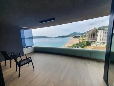 a room with a view of a beach and the ocean at Prestige Central apartments - Rafailovici in Budva