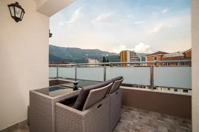 a balcony with a table and a view of a city at Apartments Budva Center 2 in Budva