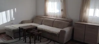a living room with a couch and a table at Adriatic Sunset House in Petrovac na Moru
