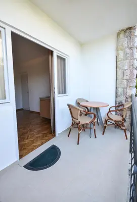 a living room with a table and chairs at Apartments Petkovic Budva in Budva