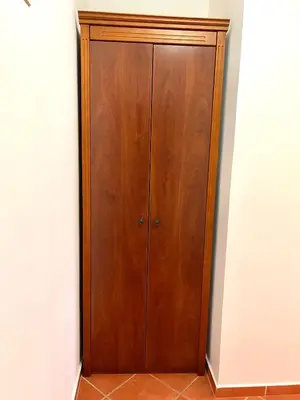 a wooden cabinet in the corner of a room at Apartments Petkovic Budva in Budva