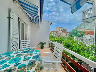 a balcony with two chairs and a table on a porch at Parapid Apartments Budva in Budva