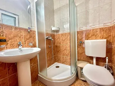 a bathroom with a toilet and a sink and a shower at Parapid Apartments Budva in Budva