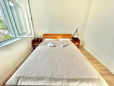 a bed in a room with a window at Parapid Apartments Budva in Budva