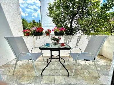a table and two chairs on a patio at Parapid Apartments Budva in Budva