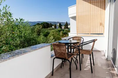 a balcony with a table and chairs and a view at Apartments Hoxha in Ulcinj