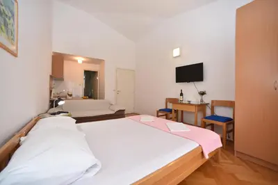 a hospital room with two beds and a television at Apartmani Soljaga in Petrovac na Moru