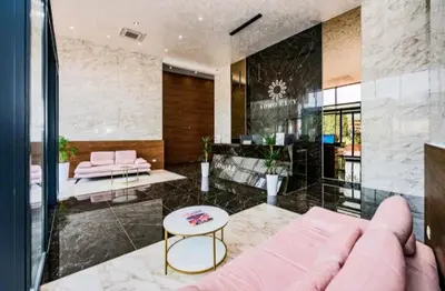 a living room with a pink couch and a table at Rent apartment lux soho city Bar in Bar