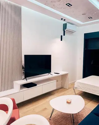 a living room with a flat screen tv on a wall at Rent apartment lux soho city Bar in Bar