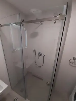 a shower with a glass door in a bathroom at Rent apartment lux soho city Bar in Bar