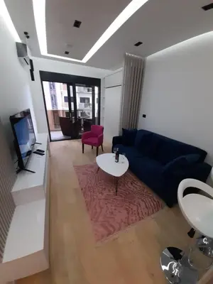 a living room with a blue couch and a table at Rent apartment lux soho city Bar in Bar