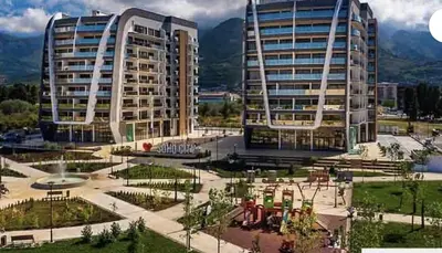 two tall buildings with a park in front of them at Rent apartment lux soho city Bar in Bar