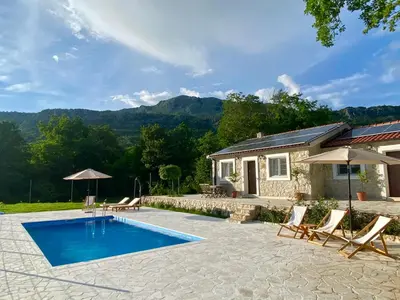 a house with a swimming pool in front of a house at BIO VILLAS in Podgorica