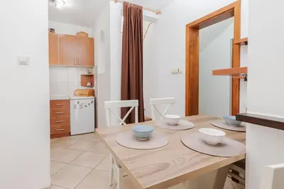 a kitchen with a wooden table with bowls on it at Sunset Rose in Kotor
