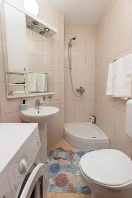 a bathroom with a sink and a toilet and a tub at Sunset Rose in Kotor