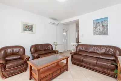 a living room with two leather couches and a coffee table at Sunset Rose in Kotor