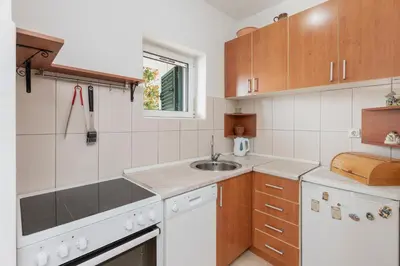 a kitchen with white appliances and a sink at Sunset Rose in Kotor