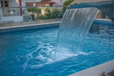 a water fountain in a swimming pool at Premium Berlin with Pool in Ulcinj