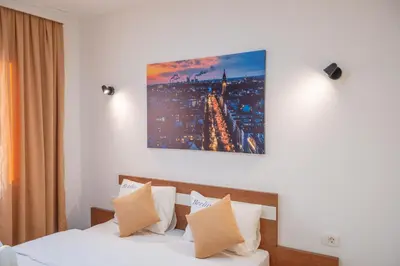 a bedroom with a bed and a painting on the wall at Premium Berlin with Pool in Ulcinj