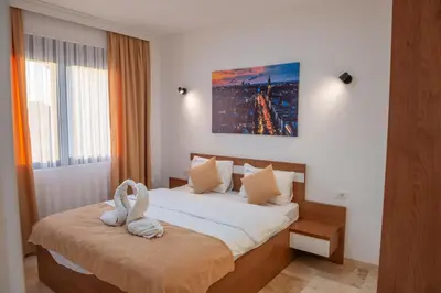 a bedroom with a bed with two towels on it at Premium Berlin with Pool in Ulcinj