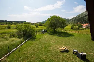 an aerial view of a field with a picnic table and bench at Lovcen mountain cottages in Vratnica