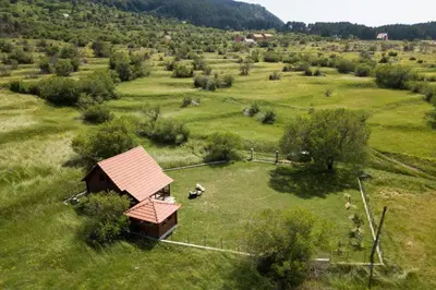 a small cabin in a field of grass at Lovcen mountain cottages in Vratnica