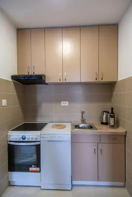 a kitchen with a white stove and a sink at Sunny Hill Suite Ljubovic in Podgorica