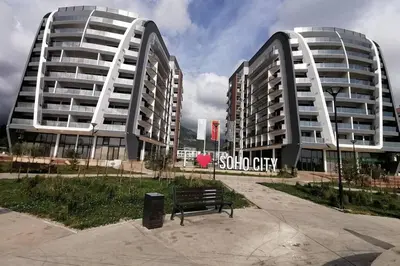 two tall buildings with a bench in front of them at Luxury Apartment Sea View Soho City 5th floor in Bar