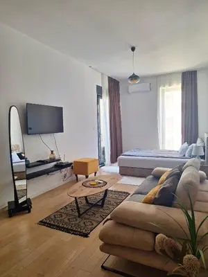 a living room with a couch and a bed at Luxury Apartment Sea View Soho City 5th floor in Bar