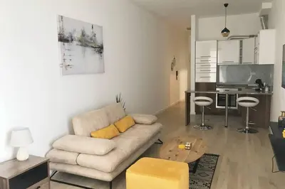 a living room with a couch and a table at Luxury Apartment Sea View Soho City 5th floor in Bar