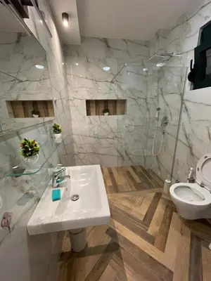 a bathroom with a sink and a shower and a toilet at White Star Apartments in Utjeha