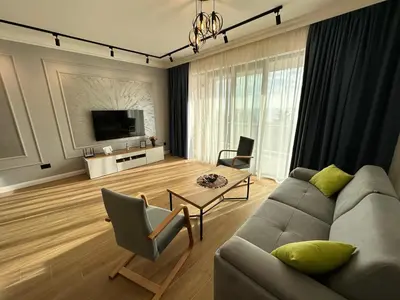 a living room with a couch and a table at White Star Apartments in Utjeha