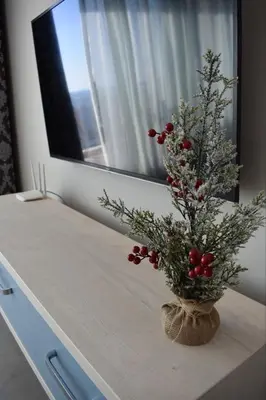 a vase with a christmas tree on a counter at White Star Apartments in Utjeha