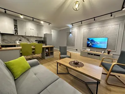 a living room with a couch and a tv at White Star Apartments in Utjeha