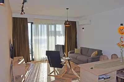 a living room with a couch and a table at White Star Apartments in Utjeha
