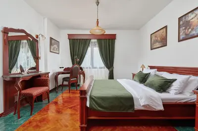 a bedroom with a bed and a desk and chairs at Apartment Aura with Sea View in Kotor