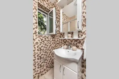 a bathroom with a sink and a mirror at Apartment Milos in Kotor