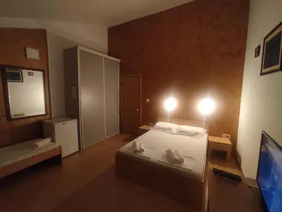 a bedroom with a bed with two shoes on it at Apartments Mare Budva in Budva