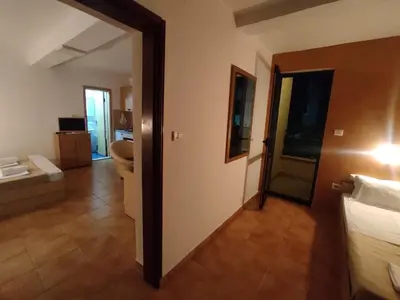 a hotel room with a bedroom and a bathroom at Apartments Mare Budva in Budva