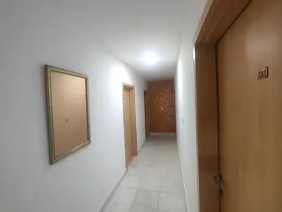 a hallway with a mirror on a white wall at Apartments Mare Budva in Budva