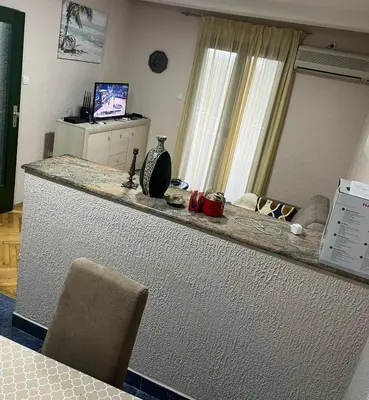 a kitchen with a counter with a television on it at Apartments Mare Budva in Budva
