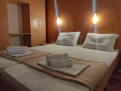 a large bed with two towels on top of it at Apartments Mare Budva in Budva