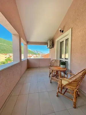 a balcony with chairs and a table and a view at Villa MD in Budva