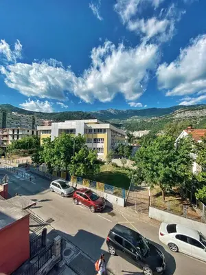 a city with cars parked in a parking lot at Villa MD in Budva