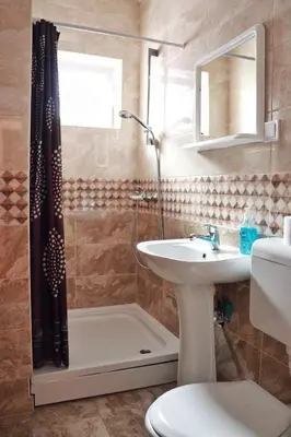 a bathroom with a sink and a shower and a toilet at Villa MD in Budva