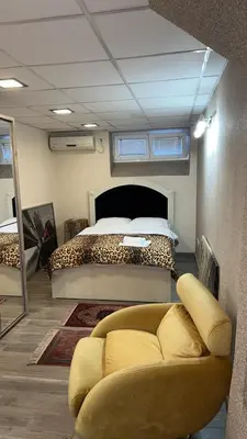 a room with a bed and a couch in front of it at Ribnica in Podgorica