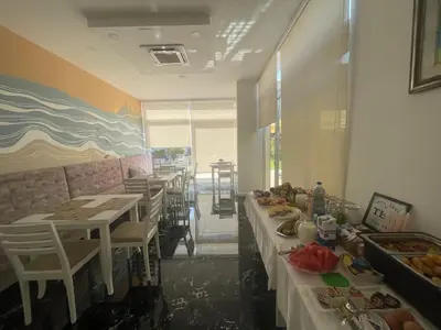 a restaurant with tables and chairs with food on them at Belami luxury apartments in Ulcinj
