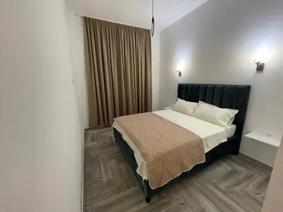 a bedroom with a bed with a black headboard at Belami luxury apartments in Ulcinj