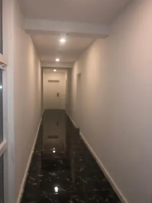 a long corridor with water in a room with white walls at Belami luxury apartments in Ulcinj