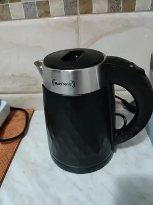 a black and silver coffee cup on a counter at Apartments BEA in Ulcinj